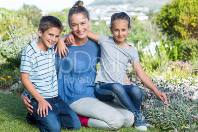 Mother and children tending to flowers