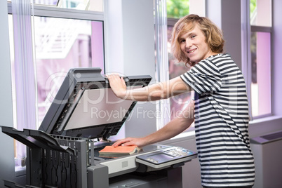 Student photocopying his book in the library