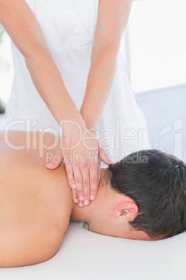 Physiotherapist doing neck massage to her patient