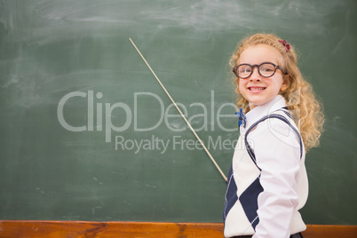 Happy pupil pointing the blackboard