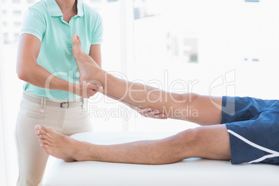 Doctor examining man leg