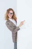 Hipster woman pointing poster smiling at camera