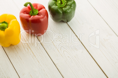 Three peppers on chopping board