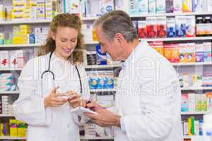 Pharmacist looking a medication for a prescription