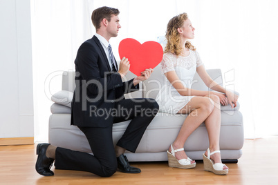 Businessman giving heart card to his girlfriend