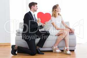 Businessman giving heart card to his girlfriend
