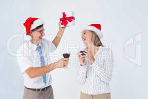 Happy geeky hipster couple drinking red wine