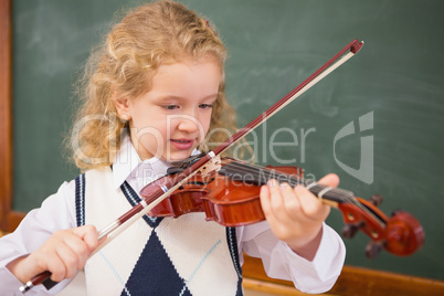 Cute pupil playing the violin