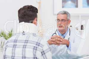 Doctor talking to patient wearing neck brace