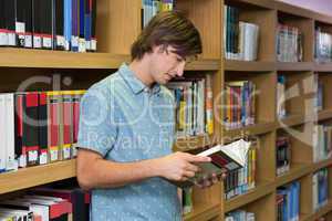 Student reading book in library