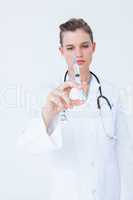 Doctor showing syringe to camera
