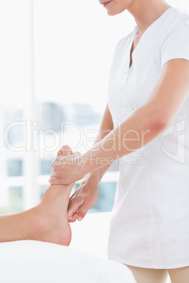 Physiotherapist doing foot massage