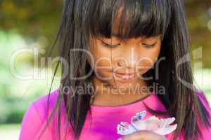 Cute little girl holding flower