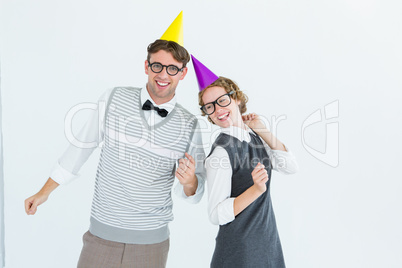 Geeky hipster couple wearing a party hat Geeky hipster couple wearing a party hat