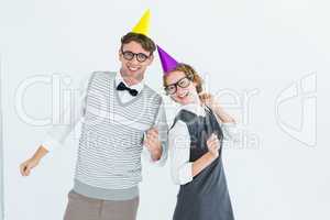Geeky hipster couple wearing a party hat