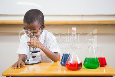 Pupil looking through microscope