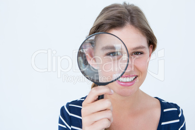 Smiling woman holding magnifying glass