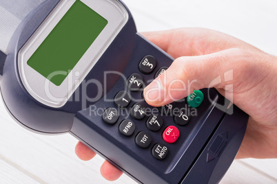 Man entering his pin on terminal