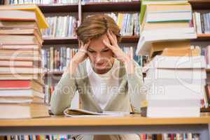 Thinking teacher sitting at library
