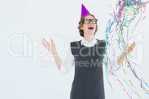 Happy geeky hipster wearing a party hat