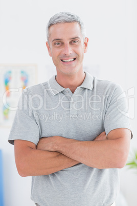 Smiling doctor standing arms crossed and looking at camera Smiling doctor standing arms crossed and looking at camera