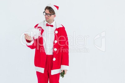 Geeky hipster in santa costume looking at beard