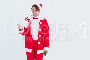 Geeky hipster in santa costume looking at beard