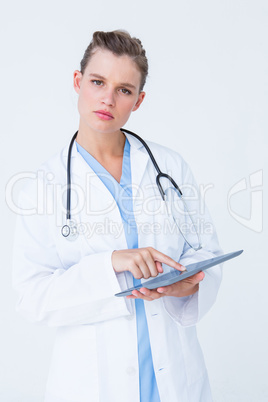 Unsure doctor pointing tablet pc