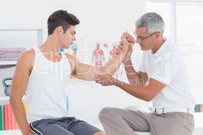 Doctor examining his patient arm