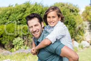 Father and son smiling at camera