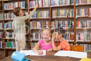 Cute pupils speaking at library