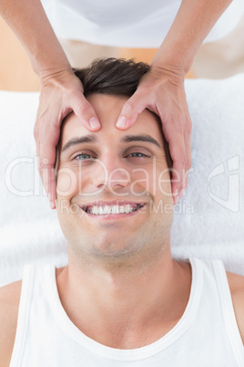 Smiling man receiving head massage