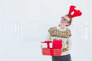 Thoughtful geeky hipster holding presents