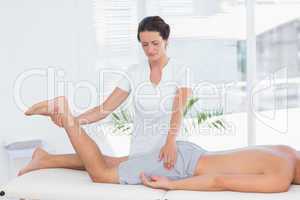 Physiotherapist doing leg massage to her patient