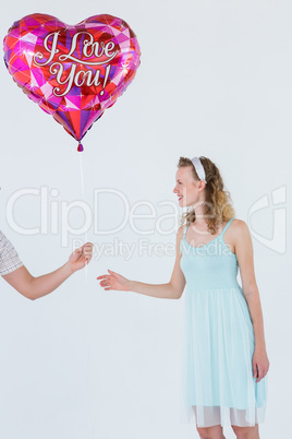 Hipster woman having heart balloon