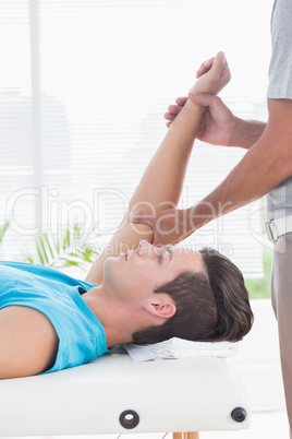 Doctor examining his patient arm