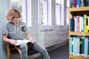 Student reading in library