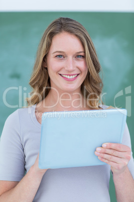 Smiling teacher holding tablet pc