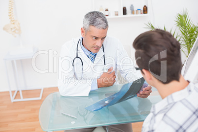 Doctor looking at X rays with his patient