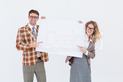 Geeky hipster couple holding poster