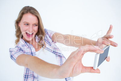 Pretty hipster taking selfie with smartphone