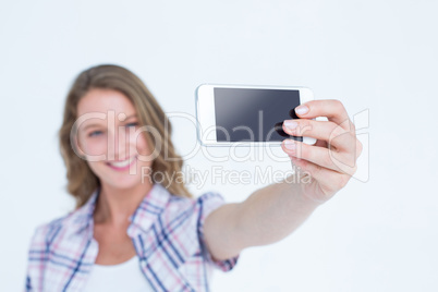 Pretty hipster taking selfie with smartphone