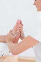 Physiotherapist doing foot massage