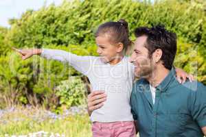 Father and daughter looking at something