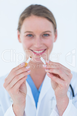 Doctor holding broken cigarette