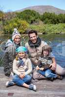 Happy casual family at a lake