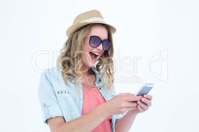 Smiling woman texting with her smartphone