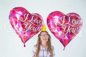 Geeky hipster holding balloons