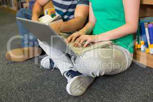 Students sitting on floor in library