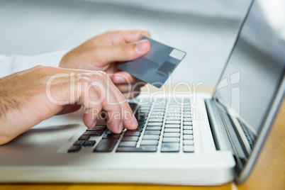 Man using laptop for online shopping